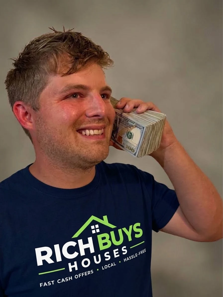 Rich smiling with a stack of money held to his ear like a phone